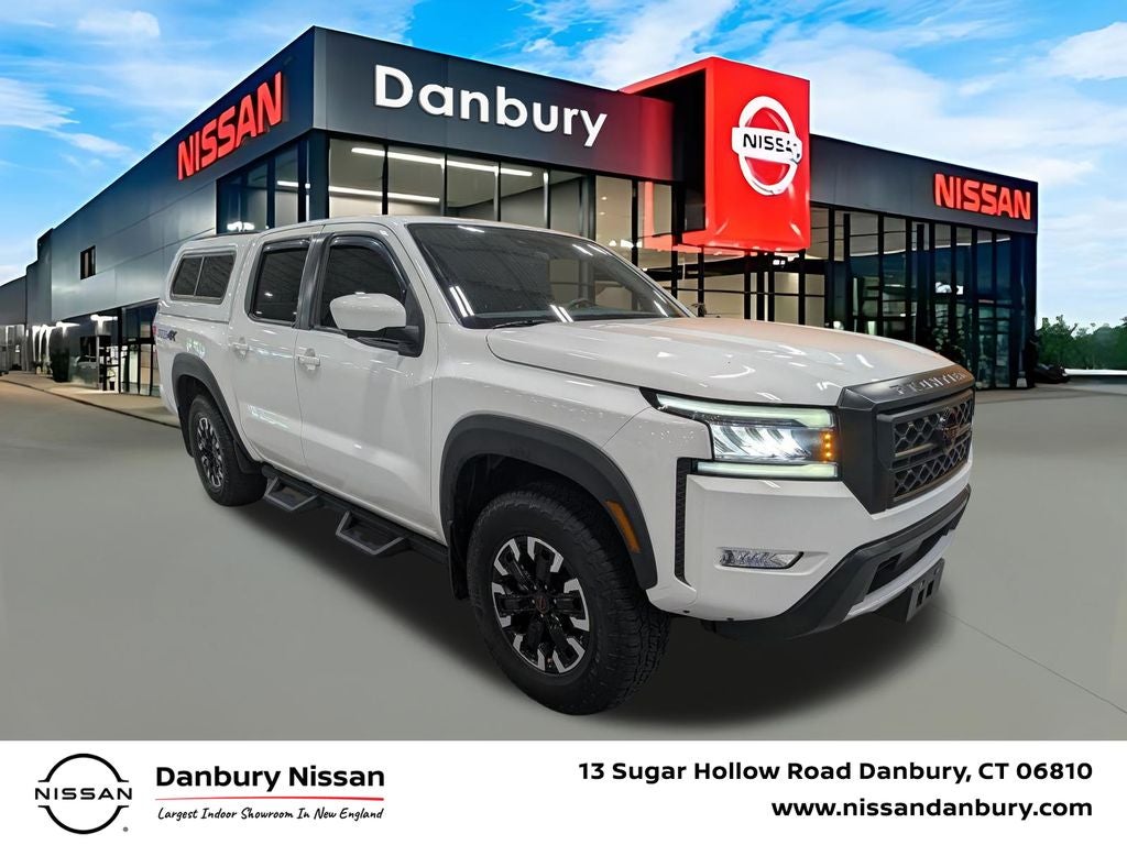 2023 Nissan Frontier PRO-4X in Glacier White — front three-quarter view